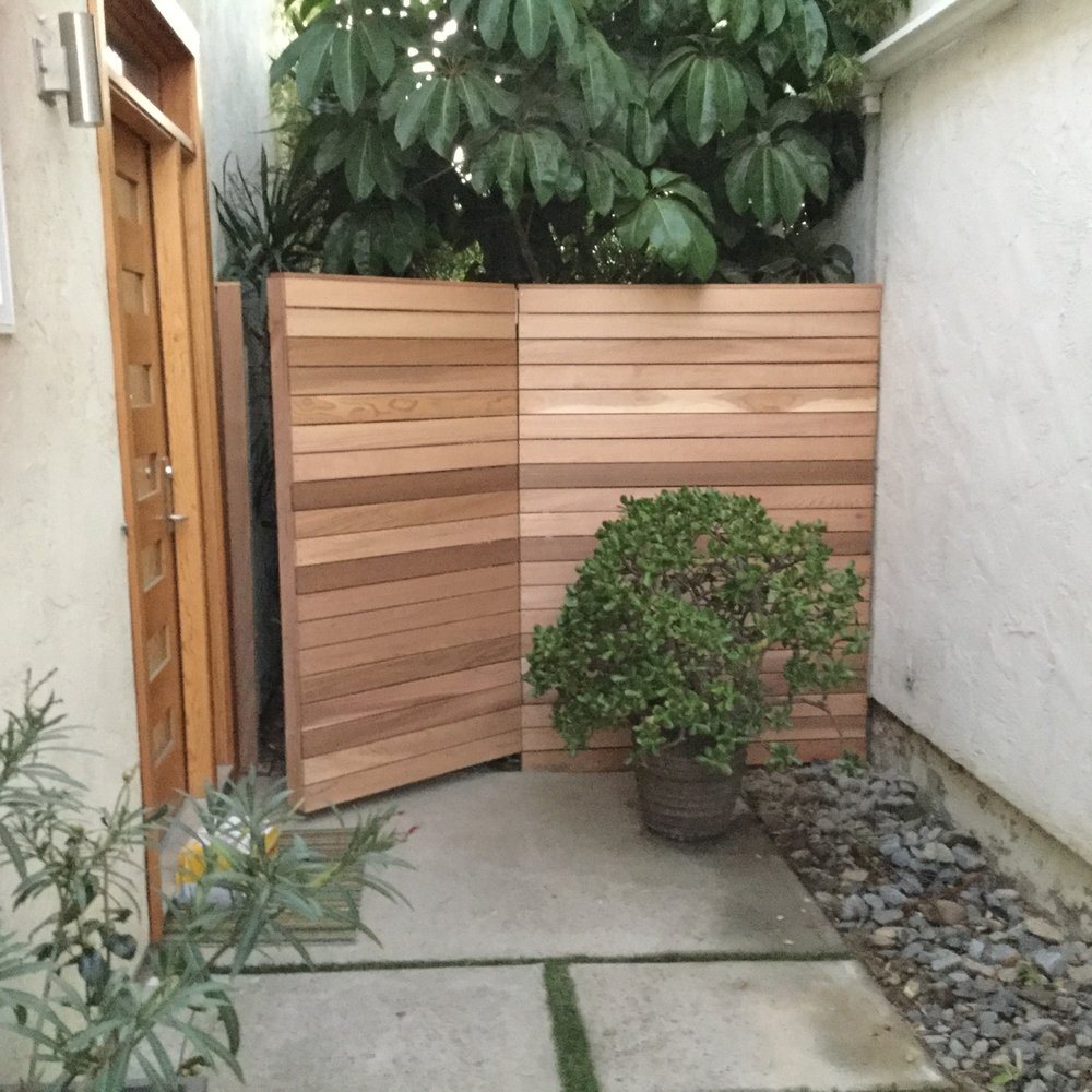 Clear cedar horizontal fence panel in a landscaped side yard