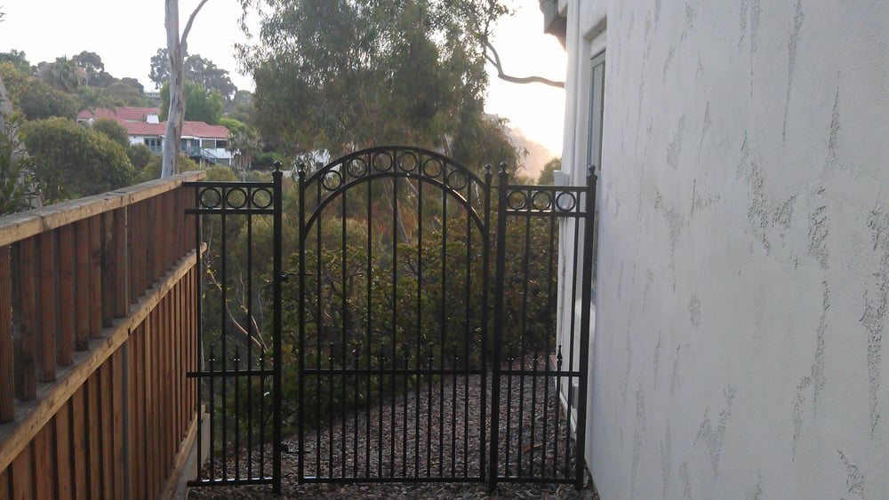 Custom wrought iron entry gates with an arched top