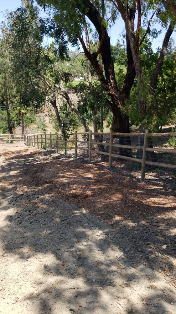 Three-rail lodge-pole ranch fence on an open property