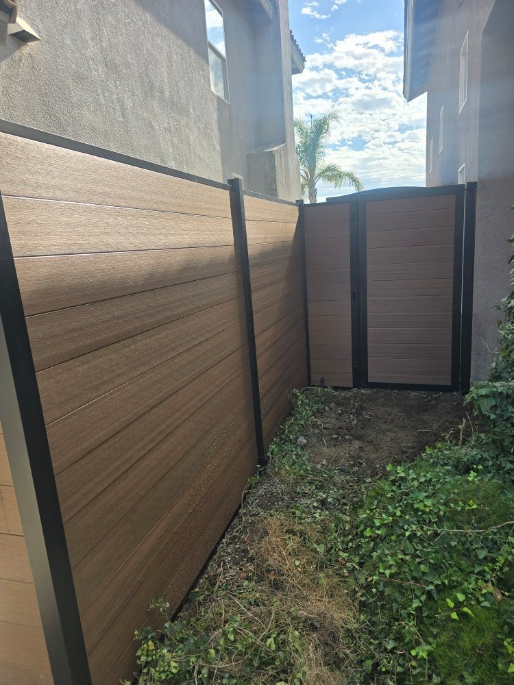 Sandstone-colored vinyl fence with composite panel sections