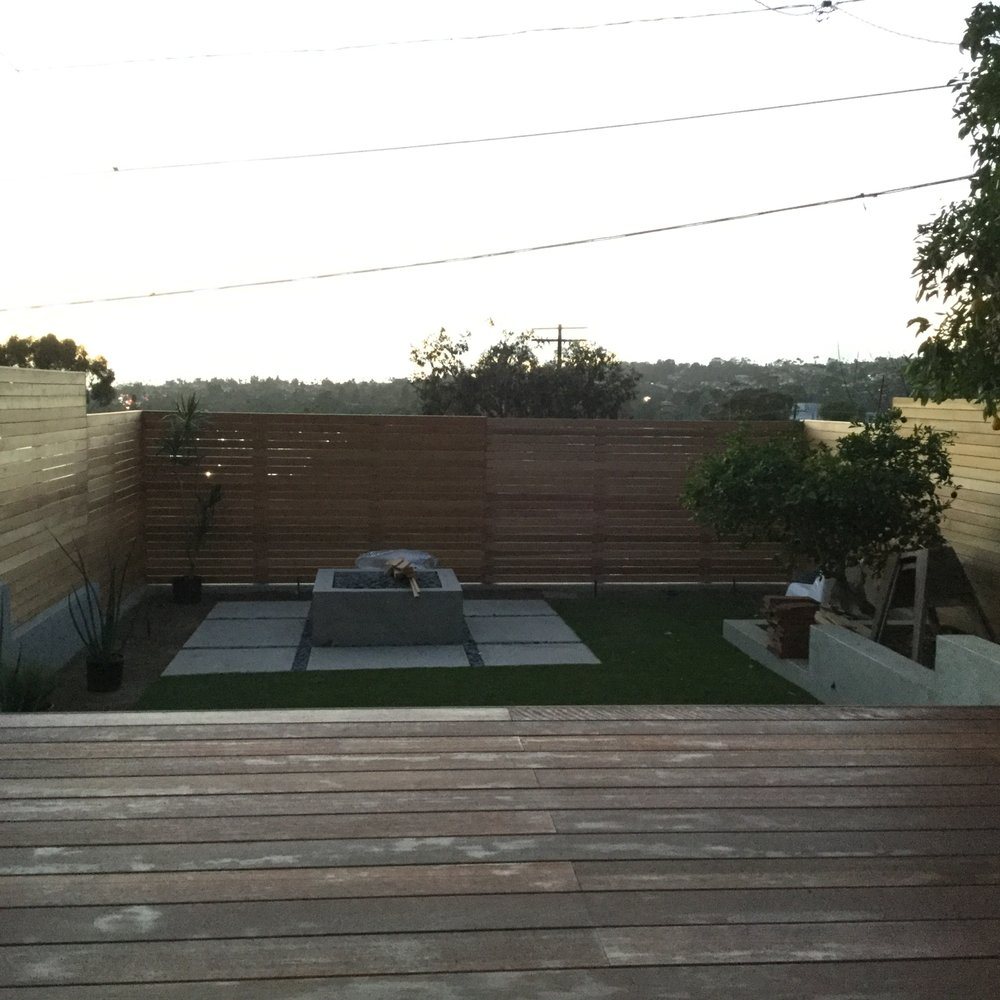 Horizontal wood fence enclosing a back yard